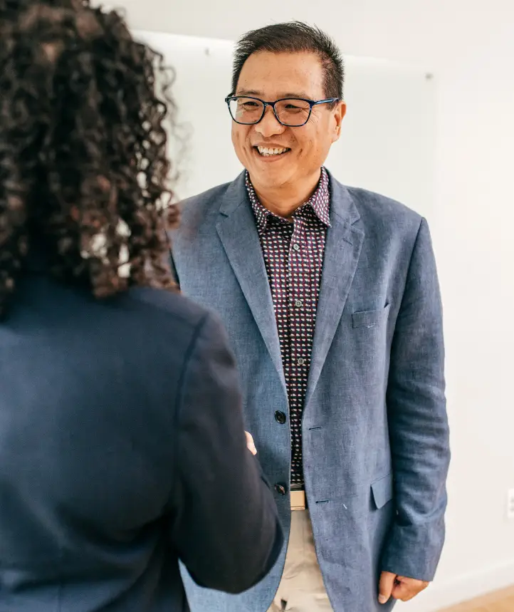Male candidate smiling and making eye contact during a professional greeting