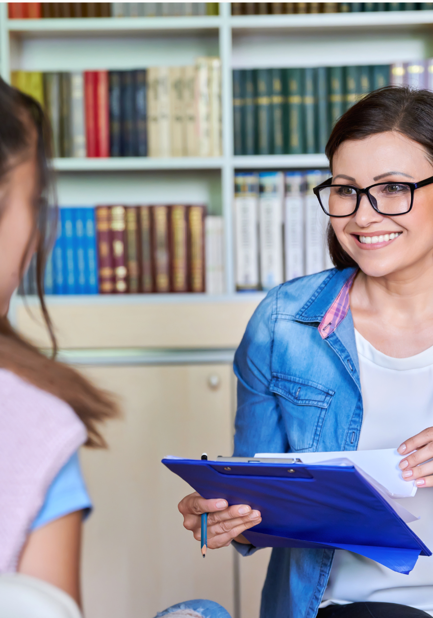 Social worker engaging in a supportive conversation with a young client in a community