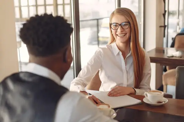 Smiling interviewer meeting with a candidate in a casual business setting